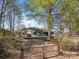 View of the driveway and carport of a single-story home with a screen porch and wheelchair ramp at 404 Forest Winds Dr, Salisbury, NC 28144