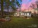 Charming single-story home featuring a screened porch, wheelchair ramp, and carport surrounded by trees at 404 Forest Winds Dr, Salisbury, NC 28144