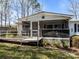Close-up view of a single-story home featuring a screened porch and wheelchair ramp at 404 Forest Winds Dr, Salisbury, NC 28144