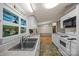 The kitchen features white cabinets, a double basin sink, and wood-look floors at 404 Forest Winds Dr, Salisbury, NC 28144