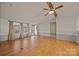 Bright living room features an entry door, windows with curtains, and wood-look floors at 404 Forest Winds Dr, Salisbury, NC 28144