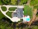 Aerial view of luxury home with pool, spa, cabana, and well-manicured lawn at 4071 King Wilkinson Rd, Lincolnton, NC 28092
