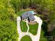 Stunning aerial view showcases circular driveway and lush wooded surroundings at 4071 King Wilkinson Rd, Lincolnton, NC 28092