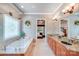 Bright bathroom featuring a soaking tub with decorative window and granite countertop double vanity at 4071 King Wilkinson Rd, Lincolnton, NC 28092