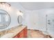 Bathroom with granite vanity, double sinks, tub, tiled shower, and white paneled doors at 4071 King Wilkinson Rd, Lincolnton, NC 28092