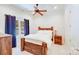 Bedroom with wooden bed, ceiling fan, and a window view of the backyard swimming pool at 4071 King Wilkinson Rd, Lincolnton, NC 28092