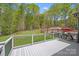 Overlooking a pristine backyard with a pool, this spacious deck is great for entertaining guests at 4071 King Wilkinson Rd, Lincolnton, NC 28092