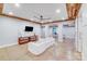 Finished basement with wooden ceiling, TV and spacious white couch at 4071 King Wilkinson Rd, Lincolnton, NC 28092