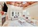 Bright living room with stone fireplace, coffered ceiling, and large windows providing natural light at 4071 King Wilkinson Rd, Lincolnton, NC 28092