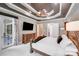 Well-appointed main bedroom with tray ceiling, access to the outdoors, and a sleek dresser at 4071 King Wilkinson Rd, Lincolnton, NC 28092