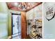 Charming wine cellar with custom racks, wood ceiling, chandelier, and concrete accent wall at 4071 King Wilkinson Rd, Lincolnton, NC 28092