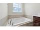 Modern bathroom showcasing a large soaking tub under a window for natural light at 408 Moondance Dr # C, Gastonia, NC 28054