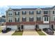 Townhomes with brick accents, garages, black shutters, and neutral-colored siding create curb appeal at 408 Moondance Dr # C, Gastonia, NC 28054