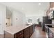 Bright open kitchen featuring granite countertops and a large island with a sink and wooden cabinets at 408 Moondance Dr # C, Gastonia, NC 28054