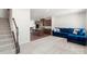 Open-concept living room with a modern kitchen, island, and plush blue couch at 408 Moondance Dr # C, Gastonia, NC 28054