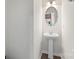 This stylish powder room features a pedestal sink and an oval mirror at 408 Moondance Dr # C, Gastonia, NC 28054
