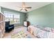 Bright bedroom featuring light green walls, ceiling fan, and large window with backyard view at 423 Wescott St # 73, Indian Trail, NC 28079
