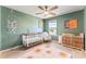 Cozy Bedroom with light green walls, white crib, rocking chair, and stylish decor at 423 Wescott St # 73, Indian Trail, NC 28079