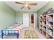 bedroom with bright green walls, ceiling fan, twin bed, and built-in bookcase at 423 Wescott St # 73, Indian Trail, NC 28079