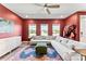 Bright and open living room with red walls, hardwood floors, and stylish furniture at 423 Wescott St # 73, Indian Trail, NC 28079