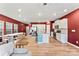 Open-concept living space with red walls, hardwood floors, kitchen, and dining area at 423 Wescott St # 73, Indian Trail, NC 28079