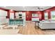 Open living space with hardwood floors and bright red walls, with kitchen and comfortable sitting area at 423 Wescott St # 73, Indian Trail, NC 28079