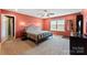 Comfortable main bedroom with carpet, a ceiling fan, and a view of the neighborhood at 423 Wescott St # 73, Indian Trail, NC 28079