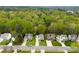 An aerial view of a tree-lined neighborhood with well-maintained homes and lush green yards at 4380 Timberwood Dr, Gastonia, NC 28052