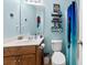 Light blue bathroom with modern fixtures, a mirror, shelving, and a shower with a decorative curtain at 4380 Timberwood Dr, Gastonia, NC 28052