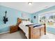 Bright bedroom with a wooden bed frame, natural light, and a guitar on the wall at 4380 Timberwood Dr, Gastonia, NC 28052