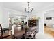 Dining room with a dark wood table set below a chandelier; overlooks the living room at 4380 Timberwood Dr, Gastonia, NC 28052