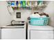 Functional laundry area with a washer, dryer, and storage space at 4380 Timberwood Dr, Gastonia, NC 28052