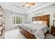 Serene main bedroom featuring a tray ceiling, a decorative headboard, and a window at 4380 Timberwood Dr, Gastonia, NC 28052
