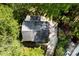 Bird's-eye view of a home highlighting its roof, driveway, and landscaping amidst a canopy of trees at 4522 Woods End Ln, Charlotte, NC 28277