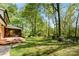 Spacious backyard with lush green grass and a screened porch at 4522 Woods End Ln, Charlotte, NC 28277