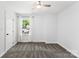 Bright bedroom featuring a ceiling fan, large window, and neutral carpet at 4522 Woods End Ln, Charlotte, NC 28277