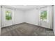 Light-filled bedroom with dual windows and neutral carpet at 4522 Woods End Ln, Charlotte, NC 28277