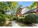 Side view of a traditional brick house with a well-maintained yard and walkway at 4522 Woods End Ln, Charlotte, NC 28277