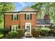 Charming brick home featuring lush landscaping, green shutters, and a classic architectural design at 4522 Woods End Ln, Charlotte, NC 28277