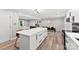Large kitchen island with white countertop overlooks the dining and living areas at 4522 Woods End Ln, Charlotte, NC 28277