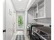 Convenient laundry room with modern appliances, storage cabinets, and access to the backyard at 4522 Woods End Ln, Charlotte, NC 28277