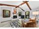Inviting living room with fireplace, exposed beams, and abundant natural light at 4522 Woods End Ln, Charlotte, NC 28277