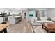 Stylish open-concept living area with a kitchen island, white cabinetry, and a comfortable sofa at 4522 Woods End Ln, Charlotte, NC 28277