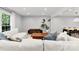 Cozy living room with a large white sectional sofa, wood accents, and recessed lighting at 4522 Woods End Ln, Charlotte, NC 28277