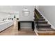 Bright living room with a staircase, featuring modern decor and hardwood floors at 4522 Woods End Ln, Charlotte, NC 28277