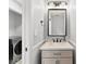 Stylish powder room with modern vanity and fixtures, and a view into the laundry room at 4522 Woods End Ln, Charlotte, NC 28277
