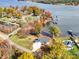 Stunning aerial view of a waterfront home with colorful fall foliage and lake access with docks at 4980 Kiser Island Rd, Terrell, NC 28682