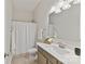 Bright bathroom with a vanity, mirror, and shower with curtain at 4980 Kiser Island Rd, Terrell, NC 28682