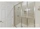 Modern bathroom featuring a tiled shower with glass doors at 4980 Kiser Island Rd, Terrell, NC 28682