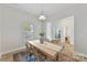 Neutral dining room with wood floors, light wood table with seating for four, and a bright window at 4980 Kiser Island Rd, Terrell, NC 28682